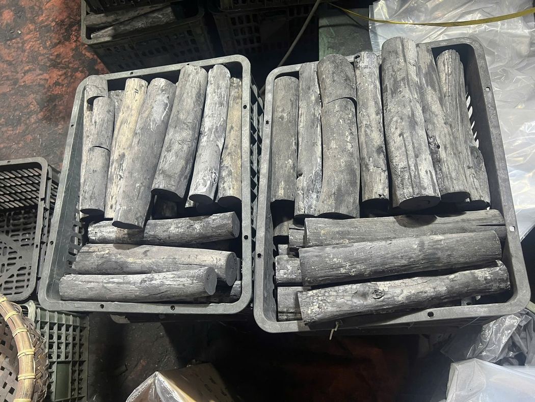 Close view of hard-stick charcoal in an export crate