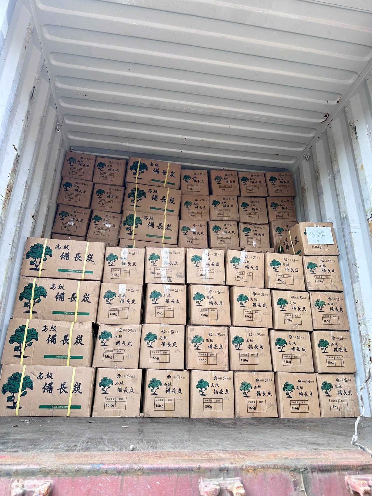 Export container loaded with charcoal cartons